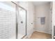 Bathroom showcasing subway tile shower with glass doors, and wood-look ceramic tile flooring at 218 Ellis Ln, Woodstock, GA 30189
