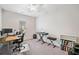Versatile bedroom set up as a home office with a desk, keyboard, and bookcase at 218 Ellis Ln, Woodstock, GA 30189