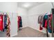 Walk-in closet with white wire shelving and neutral carpet, perfect for organizing clothes and accessories at 218 Ellis Ln, Woodstock, GA 30189