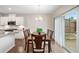 Bright dining area featuring a wood table, a chandelier, and sliding glass doors leading to the backyard at 218 Ellis Ln, Woodstock, GA 30189
