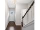 Bright foyer with hardwood floors and a staircase featuring white risers and a dark wood handrail at 218 Ellis Ln, Woodstock, GA 30189