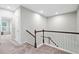 Upstairs hallway with carpet and wooden railing at 218 Ellis Ln, Woodstock, GA 30189