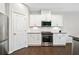 Bright kitchen with stainless steel appliances, white cabinets and a microwave at 218 Ellis Ln, Woodstock, GA 30189
