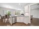 Bright kitchen with stainless steel appliances, white cabinets, and view of dining area with seating at 218 Ellis Ln, Woodstock, GA 30189
