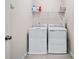 Laundry room with a washer and dryer, wire shelving, and light gray walls at 218 Ellis Ln, Woodstock, GA 30189