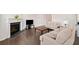 Comfortable living room with hardwood floors, a fireplace, and neutral-toned sofas provides a cozy space at 218 Ellis Ln, Woodstock, GA 30189