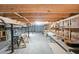 Unfinished basement with exposed wooden beams, concrete floor, and shelving units, ready for customization at 2394 Burch Ne Cir, Brookhaven, GA 30319