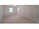 Bright bedroom features neutral carpet and double door closet, and natural light from the window at 2394 Burch Ne Cir, Brookhaven, GA 30319