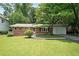 Charming brick home with well-maintained lawn, mature trees, and a one-car garage at 2394 Burch Ne Cir, Brookhaven, GA 30319
