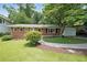 Charming brick home with well-manicured lawn, mature trees, and a convenient one-car garage at 2394 Burch Ne Cir, Brookhaven, GA 30319