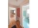 Hallway leading to a bathroom and living area showcases beautiful wood floors and vintage details like a built-in cabinet at 2394 Burch Ne Cir, Brookhaven, GA 30319