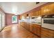 Spacious kitchen with hardwood floors, wooden cabinets, white countertops, and ample natural light from a large window at 2394 Burch Ne Cir, Brookhaven, GA 30319