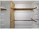 Spacious walk-in closet with adjustable wire shelving and wooden rods for optimal storage organization at 2394 Burch Ne Cir, Brookhaven, GA 30319