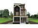 Modern three-story home featuring multiple balconies, dark accents and manicured lawn at 339 Peachtree Ne Ave, Atlanta, GA 30305