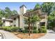 Charming condo complex with lush landscaping, mature trees and welcoming signage at 408 Coleraine Se, Smyrna, GA 30080