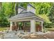 A community gazebo featuring a covered seating area, walkway, manicured landscaping, and mature trees at 408 Coleraine Se, Smyrna, GA 30080