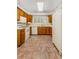 Bright kitchen with wooden cabinets, white appliances, and a window providing natural light at 408 Coleraine Se, Smyrna, GA 30080