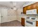 Functional kitchen with light wood cabinets, white appliances, and cheerful floral wallpaper at 408 Coleraine Se, Smyrna, GA 30080