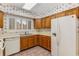 Spacious kitchen with oak cabinets, white appliances, and a window providing natural light at 408 Coleraine Se, Smyrna, GA 30080