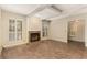 Bright living room with fireplace, beamed ceiling, and plantation shutters at 408 Coleraine Se, Smyrna, GA 30080