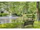 A serene pond with fountain views, a bench, and lush landscaping, all within a community setting at 408 Coleraine Se, Smyrna, GA 30080