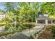 A beautifully landscaped pond with a fountain, gazebo, walkway and lush landscaping at 408 Coleraine Se, Smyrna, GA 30080