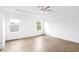 Bright main bedroom with a tray ceiling, fan, and lots of natural light at 2528 Morgan Chase Dr, Buford, GA 30519