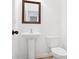 This powder room offers a pedestal sink and classic mirror frame at 2528 Morgan Chase Dr, Buford, GA 30519