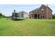 Spacious backyard featuring a play set, trampoline, and lush green grass at 3352 Stone Point Way, Buford, GA 30519