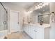 Bright bathroom showcasing a double vanity, granite countertops, tile floor, walk-in shower, and framed mirrors at 3352 Stone Point Way, Buford, GA 30519