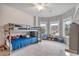 Charming ' bedroom features a bunk bed and play area by the windows at 3352 Stone Point Way, Buford, GA 30519