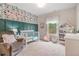 Cozy Bedroom with decorative wallpaper, glider, crib, and house-shaped bookshelf at 3352 Stone Point Way, Buford, GA 30519