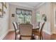 Cozy breakfast nook with hardwood floors, round table, and natural light coming through the window at 3352 Stone Point Way, Buford, GA 30519