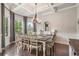 Elegant dining room featuring coffered ceilings, a chandelier, and large windows that provide abundant natural light at 3352 Stone Point Way, Buford, GA 30519