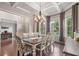 Elegant dining room featuring coffered ceilings, a chandelier, and large windows that provide abundant natural light at 3352 Stone Point Way, Buford, GA 30519