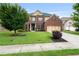 Lovely two-story brick home with a well-manicured lawn, mature trees, and a two-car garage at 3352 Stone Point Way, Buford, GA 30519
