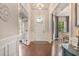 Inviting foyer with hardwood floors, elegant decor, and a view into the adjacent dining and living areas at 3352 Stone Point Way, Buford, GA 30519