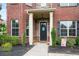 Charming brick home entrance with a covered porch and landscaped garden, enhancing curb appeal at 3352 Stone Point Way, Buford, GA 30519