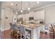 Well-lit kitchen featuring an island with barstool seating, granite countertops, and stainless steel appliances at 3352 Stone Point Way, Buford, GA 30519