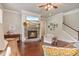 Comfortable living room with hardwood floors, stone fireplace, beach view television and plenty of natural light at 3352 Stone Point Way, Buford, GA 30519