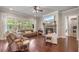 Inviting living room with hardwood floors, stone fireplace, large windows, and comfortable leather seating at 3352 Stone Point Way, Buford, GA 30519