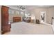 Large living room featuring a leather sofa, piano, neutral walls, plush carpet, and plenty of natural light at 3352 Stone Point Way, Buford, GA 30519