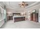 Inviting main bedroom features neutral paint, tray ceiling, ceiling fan, soft carpet, and a view to the ensuite at 3352 Stone Point Way, Buford, GA 30519