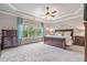 Relaxing main bedroom boasts a tray ceiling, ceiling fan, neutral paint, and bright windows at 3352 Stone Point Way, Buford, GA 30519