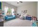 Spacious playroom with plush carpeting, bright decor, a modular blue sofa, and ample storage at 3352 Stone Point Way, Buford, GA 30519