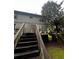 Backyard featuring a wooden staircase leading to an aging deck needing replacement at 5568 Bradley Cir, Lithonia, GA 30038