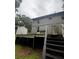 Backyard view featuring a damaged deck area, in need of replacement, leading to the upper level at 5568 Bradley Cir, Lithonia, GA 30038