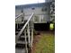 The backyard has a wooden staircase, and you can see damage to the deck and siding at 5568 Bradley Cir, Lithonia, GA 30038