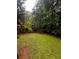 The backyard is spacious and lush, showcasing a well-maintained lawn and fence at 5568 Bradley Cir, Lithonia, GA 30038
