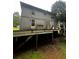 Back of home featuring an elevated back deck and staircase needing repair at 5568 Bradley Cir, Lithonia, GA 30038